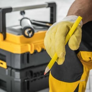 contractor-worker-with-pencil-in-his-hand-and-tools-box.jpg